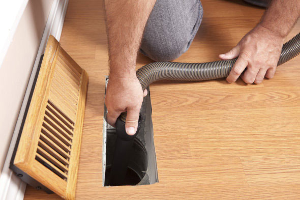 Technician Brushing Air Vent