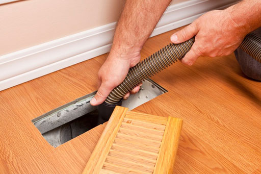 Technician Brushing Air Vent